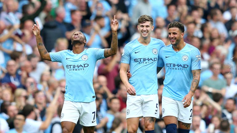 Raheem Sterling celebrates his opener alongside teammates John Stones and Kyle Walker