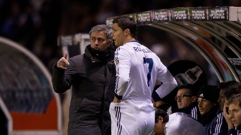Head coach Jose Mourinho (L) of Real Madrid CF gives instructions to Cristiano Ronaldo (2ndl) on the desk during the La Liga match between RC Deportivo La Coruna and Real Madrid CF at Riazor Stadium on February 23, 2013 in La Coruna, Spain