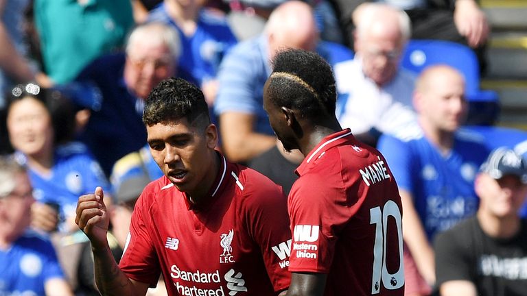 Roberto Firmino of Liverpool celebrates after scoring his team's second goal with Sadio Mane during the Premier League match between Leicester City and Liverpool FC at The King Power Stadium on September 1, 2018