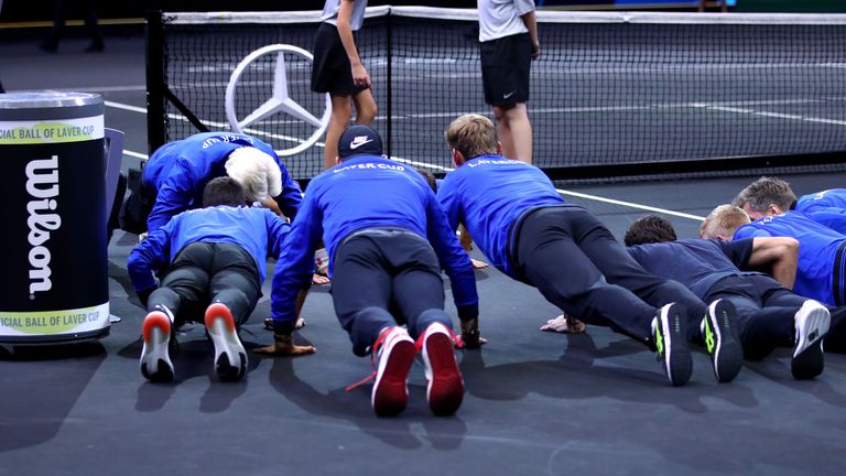 Team Europe Roger Federer of Switzerland celebrates with his teammates by doing push-ups after defeating Team World John Isner of the United States in their Men's Singles match on day three of the 2018 Laver Cup at the United Center on September 23, 2018 in Chicago, Illinois.