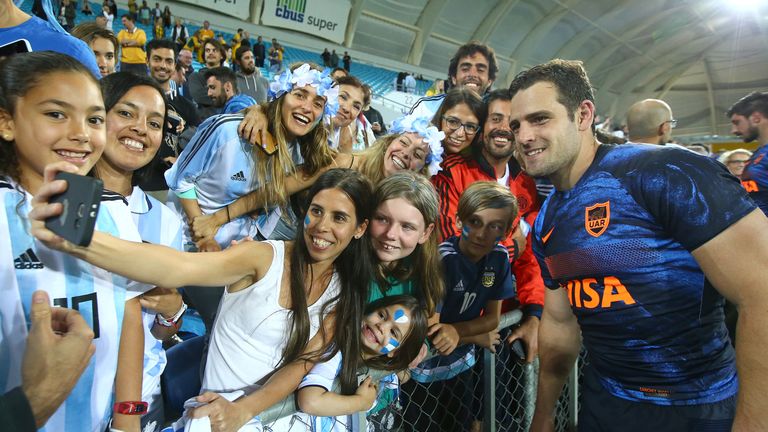 Argentina's Nicolas Sanchez poses with some of his many fans