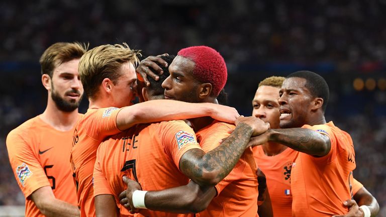 Ryan Babel celebrates with team-mates after drawing the Netherlands level against France