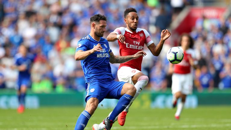 Sean Morrison of Cardiff City battles for possession with Pierre-Emerick Aubameyang of Arsenal during the Premier League match between Cardiff City and Arsenal FC at Cardiff City Stadium on September 2, 2018 in Cardiff, United Kingdom