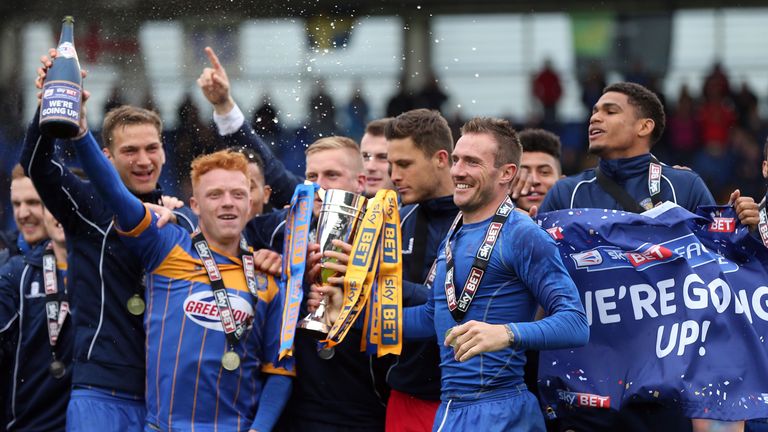 Liam Lawrence lifts the runners-up trophy alongside Ryan Woods as Shrewsbury Town celebrate promotion following the Sky Bet League Two match between Shrewsbury Town and Plymouth Argyle at Greenhous Meadow on May 02, 2015