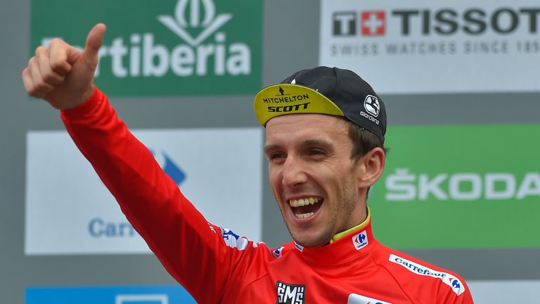 Mitchelton-Scott's British cyclist Simon Philip Yates celebrates on the podium with the leader's red jersey after the 20th stage of the 73rd edition of 'La Vuelta' Tour of Spain cycling race, a 97,3 km hilly route from Les Escaldes to Collada de la Gallina in Andorra, on September 15, 2018