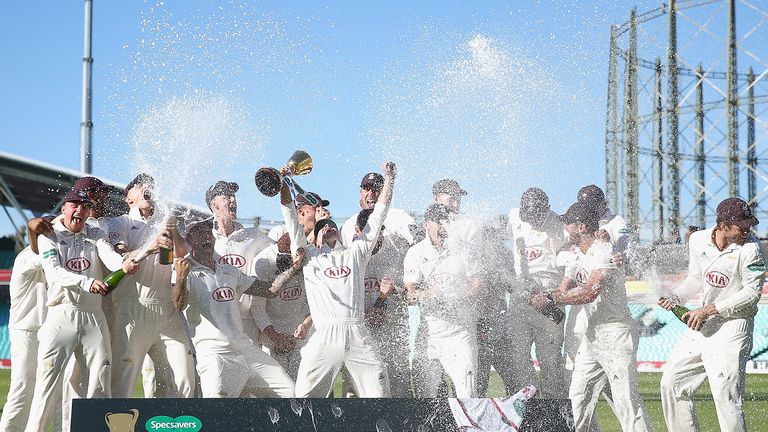 Surrey captain Rory Burns lifts the County Championship trophy
