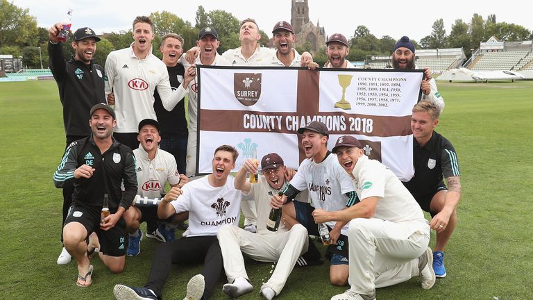 The Surrey squad celebrate on the pitch after Surrey had beaten Worcestershire to win the First Division Championship after day four of the Specsavers County Championship Division One match between Worcestershire and Surrey at New Road on September 13, 2018 in Worcester, England