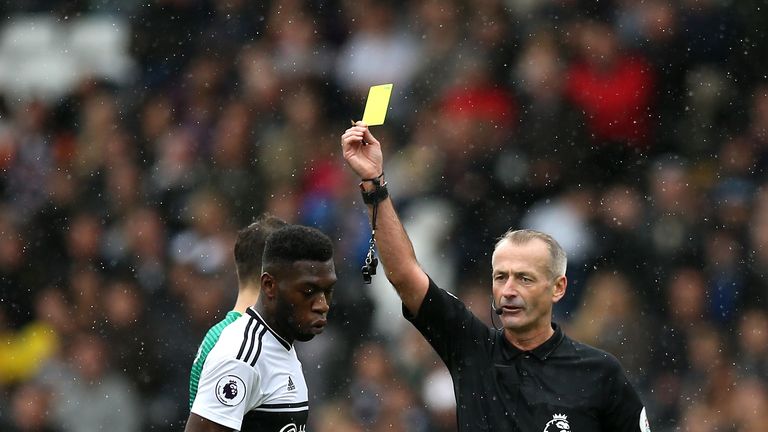 Timothy Fosu-Mensah is shown a yellow card by Martin Atkinson 