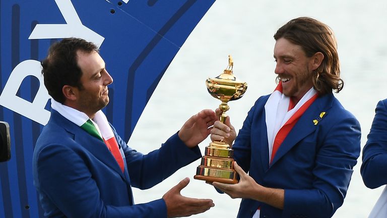 Tommy Fleetwood (R) and Francesco Molinari hold the trophy as they celebrate winning the 42nd Ryder Cup at Le Golf National Course at Saint-Quentin-en-Yvelines, south-west of Paris, on September 30, 2018