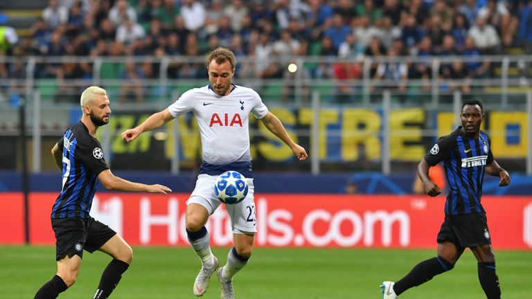 Tottenham's Danish midfielder Christian Eriksen (C) controls the ball under pressure from Inter Milan's Croatian midfielder Marcelo Brozovic (L) during the UEFA Champions League group stage football match Inter Milan vs Tottenham on September 18, 2018 at the San Siro stadium in Milan