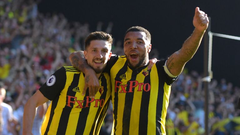 Craig Cathcart (L) celebrates with Watford's English striker Troy Deeney after scoring