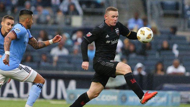 Sep 8, 2018; New York, NY, USA; D.C. United forward Wayne Rooney (9) plays the ball in font New York City defender Ronald Matarrita (22) during the first half at Yankee Stadium. Mandatory Credit: Vincent Carchietta-USA TODAY Sports