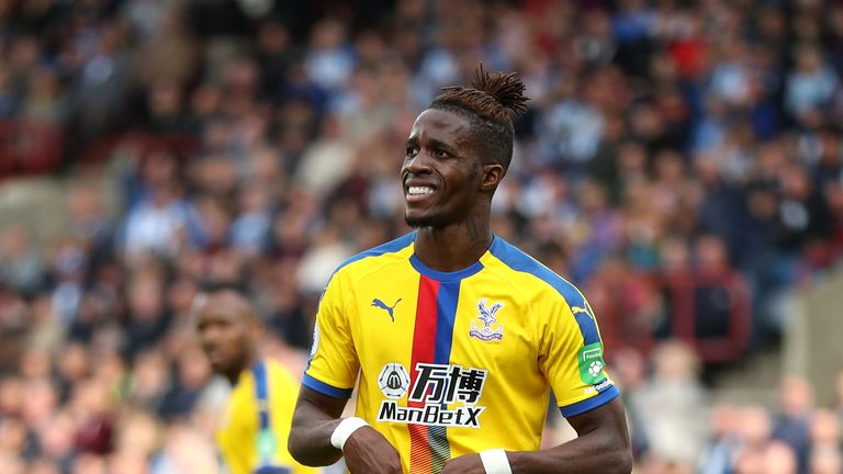 Wilfried Zaha celebrates after the Premier League match between Huddersfield Town and Crystal Palace at John Smith's Stadium on September 15, 2018 in Huddersfield, United Kingdom.