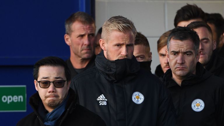 Aiyawatt Srivaddhanaprabha, son of owner Vichai Srivaddhanaprabha, and Leicester City goalkeeper Kasper Schmeichel look at floral tributes left to victims of the helicopter crash outside the King Power Stadium 
