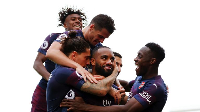 Alexandre Lacazette is mobbed by team-mates after scoring his second goal