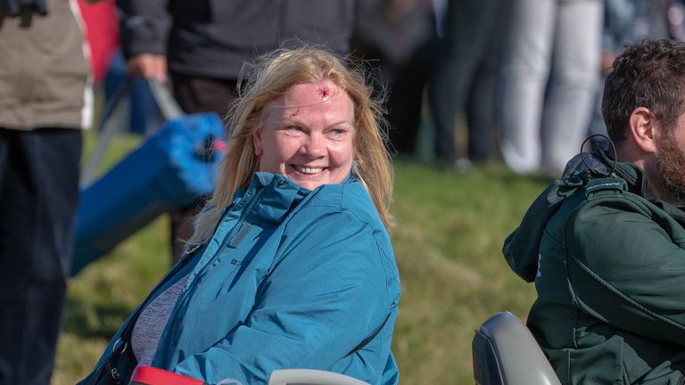 A spectator who was hit with Tyrell Hatton's tee shot at the 15th hole is taken for treatment