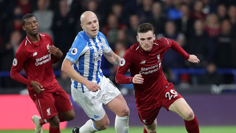 Andrew Robertson in action with Aaron Mooy during Liverpool's match at Huddersfield