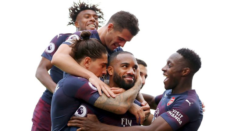 Alexandre Lacazette of Arsenal celebrates with teammates after scoring his team's second goal during the Premier League match between Fulham FC and Arsenal FC at Craven Cottage on October 7, 2018 in London, United Kingdom