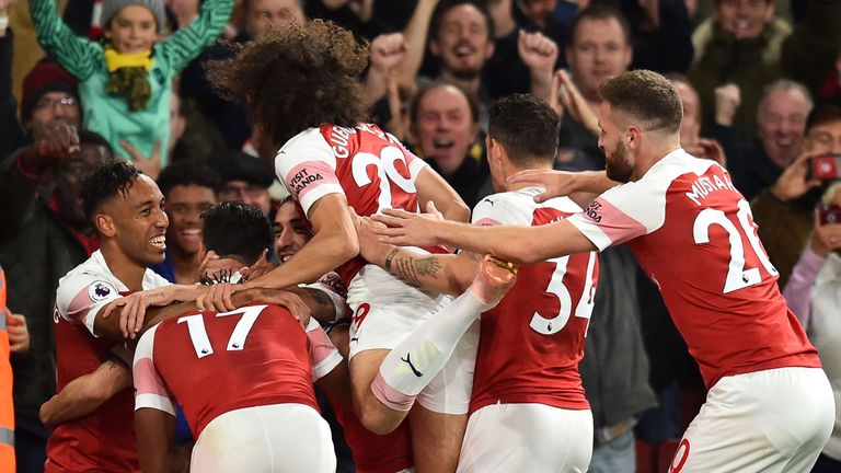 Arsenal&#39;s Pierre-Emerick Aubameyang celebrates with teammates after scoring their third goal during the English Premier League football match between Arsenal and Leicester City at the Emirates Stadium in London.