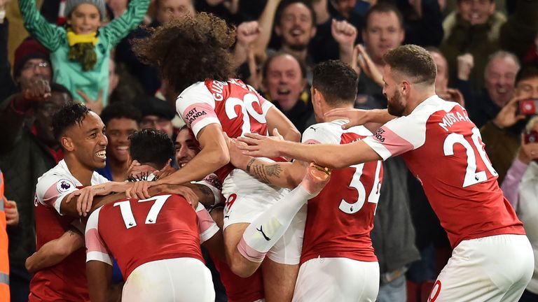 Arsenal's Pierre-Emerick Aubameyang celebrates with teammates after scoring their third goal during the English Premier League football match between Arsenal and Leicester City at the Emirates Stadium in London.