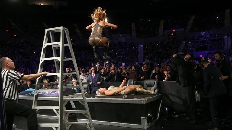 becky lynvh jumps off ladder through table on charlotte fliar at wwe evolution