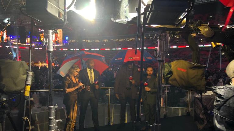 The Sky Boxing team battle the conditions ringside at Wembley