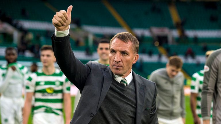 Celtic manager Brendan Rodgers and the players applaud the fans at full-time