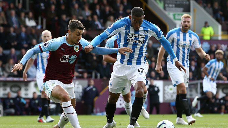 Rajiv van La Parra of Huddersfield Town is challenged by Matthew Lowton of Burnley during the Premier League match between Burnley FC and Huddersfield Town at Turf Moor on October 6, 2018