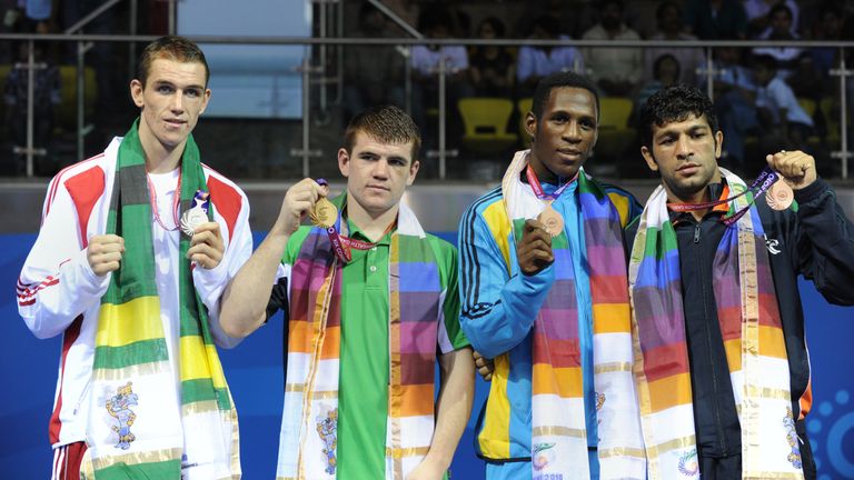 Patrick Gallagher of Northern Ireland (2L) poses with his gold medal with Callum Smith of England (L) silver medallist and bronze medallists Carl Hield of Bahamas (2R) and Dilbag Singh (R) of India during the medal ceremony after the welterweight 69kg boxing event at The Commonwealth Games at The Talkatora Indoor Stadium in New Delhi on October 13, 2010. Gallagher won 11-6. The Commonwealth Games are taking place in the Indian capital from October 3-14.