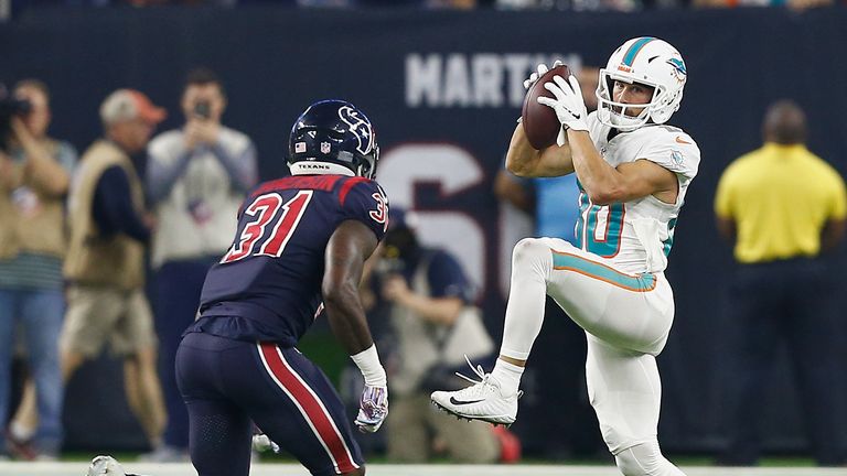 Danny Amendola #80 of the Miami Dolphins catches a pass as Natrell Jamerson #31 of the Houston Texans moves in for the tackle second quarter at NRG Stadium on October 25, 2018 in Houston, Texas. 