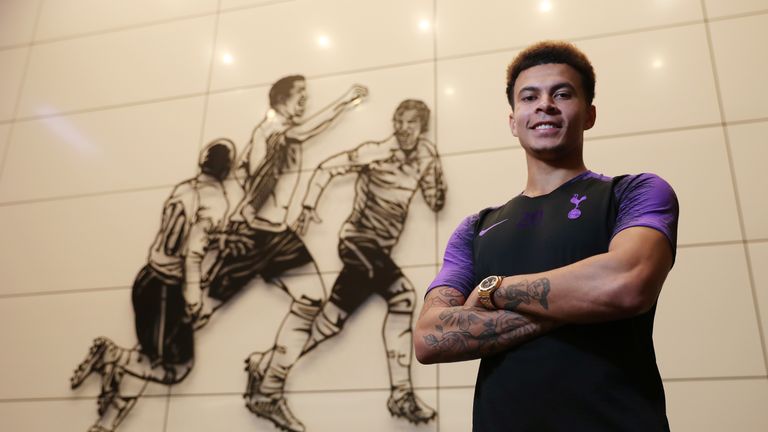 Dele Alli poses after signing a new contract with Tottenham Hotspur