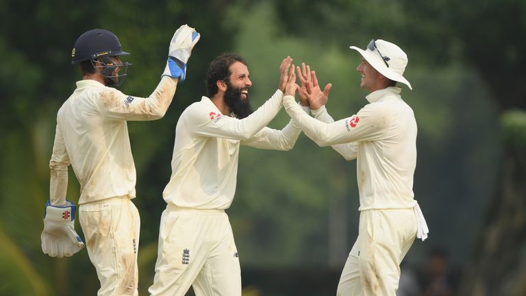 Moeen Ali celebrates a wicket with England team-mate Joe Denly