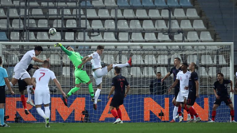 Players contest an England corner during the match