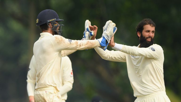 Moeen Ali exchanges a high five with Ben Foakes, one of three England wicketkeepers on day one against the Sri Lanka Board XI