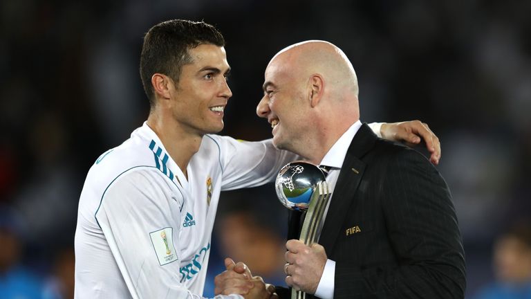 Cristiano Ronaldo of Real Madrid collects his adidas Golden Ball trophy from Gianni Infantino during the FIFA Club World Cup UAE 2017 Final between Gremio and Real Madrid at the Zayed Sports City Stadium on December 16, 2017 in Abu Dhabi, United Arab Emirates.