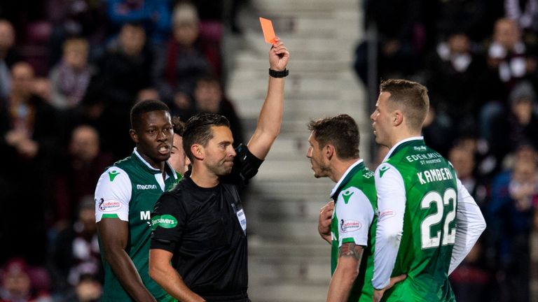 Referee Andrew Dallas shows a red card to Hibernian’s Florain Kamberi