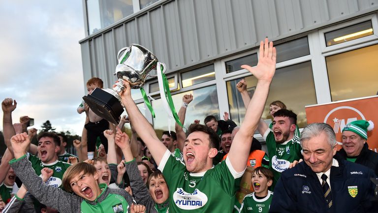 Niall Friel of Gaoth Dobhair holds aloft the Maguire Cup