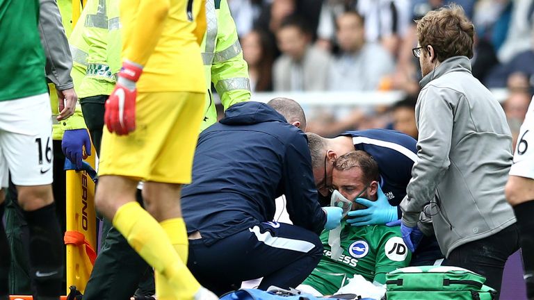 Glenn Murray is tended to following a clash of heads with Newcastle's Federico Fernandez
