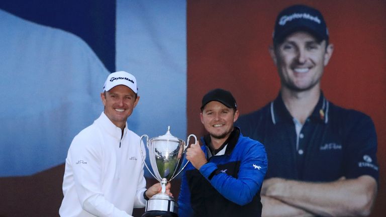 Eddie Pepperell holds his Sky Sports British Masters trophy alongside tournament host Justin Rose