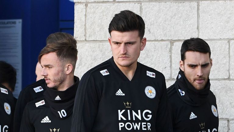 James Maddison and Harry Maguire look at floral tributes left for victims of the helicopter crash outside the King Power Stadium