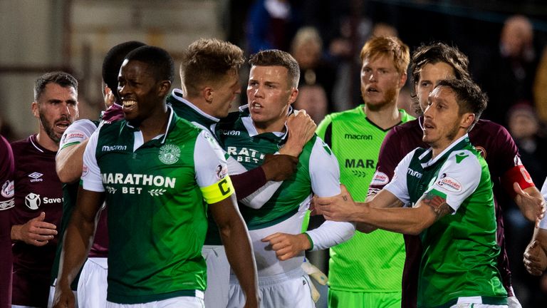 Hibernian’s Florain Kamberi is held back by his teammates