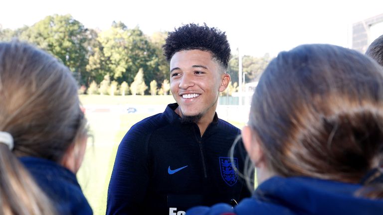 England&#39;s Jadon Sancho stops to sign autographs and pose for photos during a training session at St George&#39;s Park