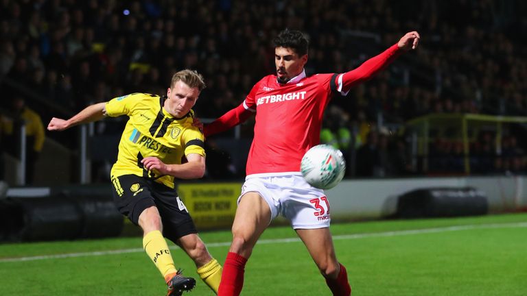 Jamie Allen of Burton Albion beats Gil Dias of Nottingham Forest during the Carabao Cup Fourth Round match between Burton Albion and Nottingham Forest at Pirelli Stadium