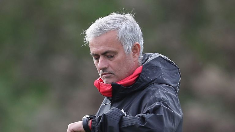 Jose Mourinho looks at his watch during training