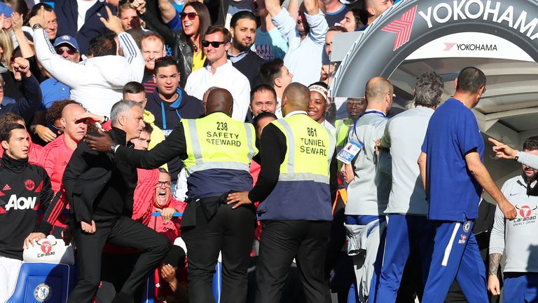 Jose Mourinho reacts to a member of Chelsea's backroom staff over-celebrating a stoppage time equaliser