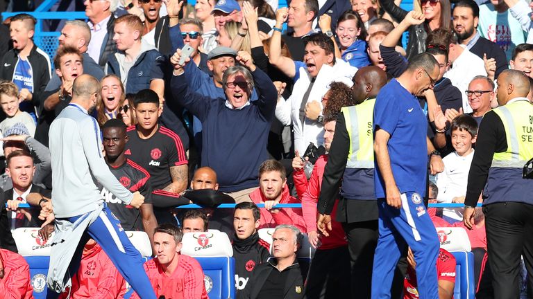 A member of Chelsea's backroom staff celebrates their stoppage time equaliser in front of Jose Mourinho