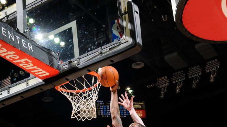 Kawhi Leonard #2 of the San Antonio Spurs shoots against Gordon Hayward #20 of the Utah Jazz at the AT&T Center on December 31, 2011 in San Antonio, Texas.