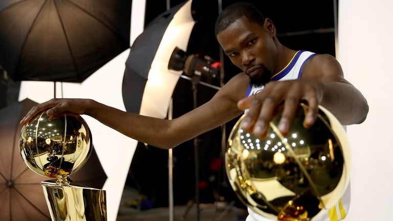 Kevin Durant #35 of the Golden State Warriors poses with two Larry O'Brien NBA Championship Trophies and two NBA Finals MVP trophies during the Golden State Warriors media day on September 24, 2018 in Oakland, California