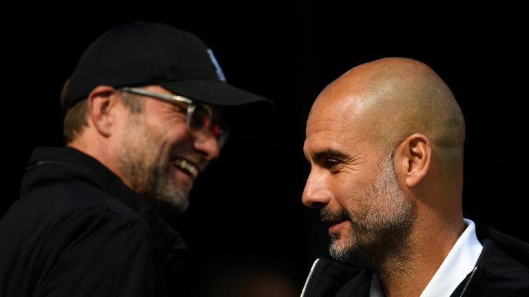  Jurgen Klopp, Manager of Liverpool smiles as Josep Guardiola, Manager of Manchester City looks on prior to the Premier League match between Manchester City and Liverpool at Etihad Stadium on September 9, 2017