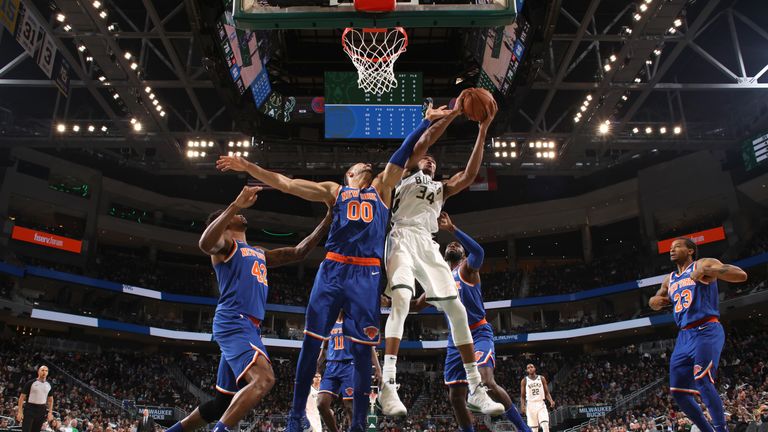  Giannis Antetokounmpo #34 of the Milwaukee Bucks rebounds the ball against the New York Knicks on October 22, 2018 at Fiserv Forum in Milwaukee, Wisconsin